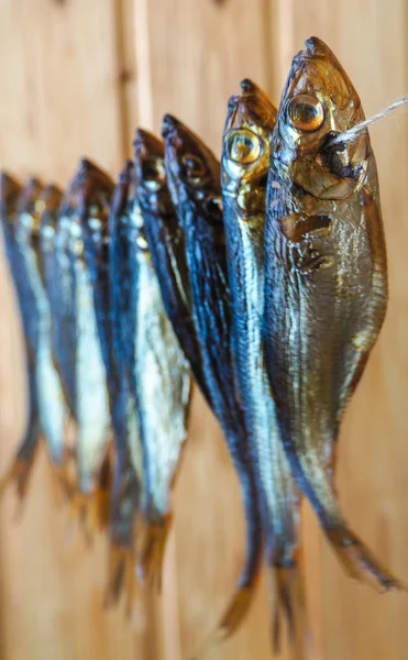 Smoked herring fish. Delicious smoked fish on the burlap.