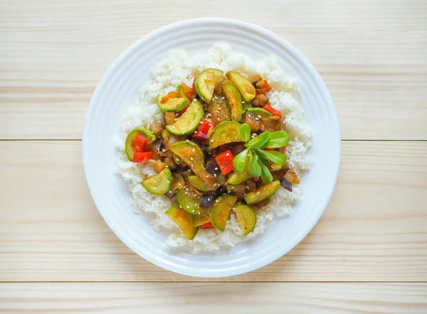 stock image Risotto with zucchini and hot pepper. Delicious vegetarian food. White rice with a side dish of zucchini with vegetables.