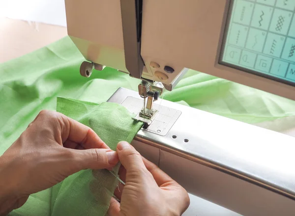 Seamstress works on a sewing machine. Stages of the production cycle on a sewing machine. — Stock Photo, Image