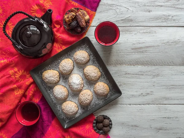 Handgemachte Ramadan-Bonbons werden mit Tee auf dem Tisch serviert. ägyptische Kekse "kahk el eid" - Kekse des islamischen Festes el fitr. — Stockfoto