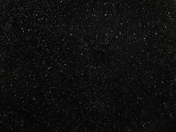 Stars in a black sky, abstract black background with white dots