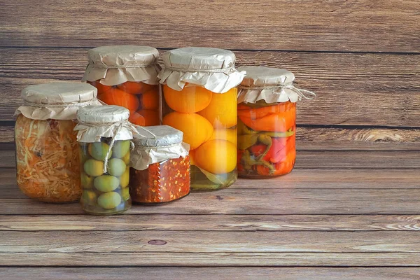 Marinated pickles variety preserving jars on the kitchen wooden table. Fermented homemade food. — Stock Photo, Image