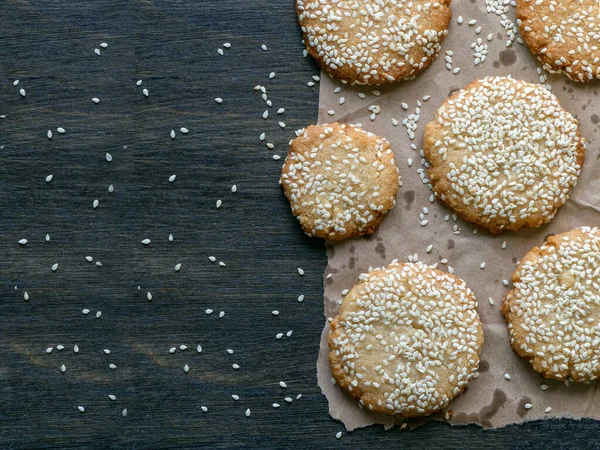 Homemade Vegan Tahini cookies are laid out on a dark table