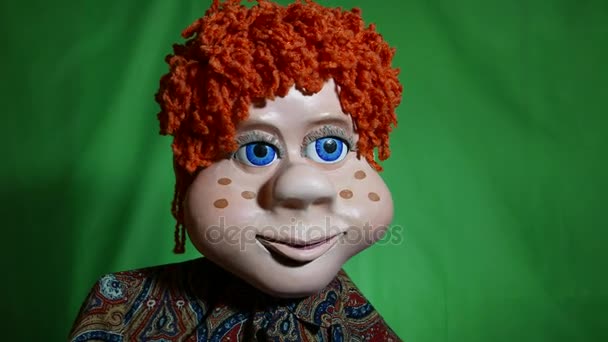 Doll young guy is a TV show. Fairytale character with orange curly hair Blue eyes and a fantastic charismatic appearance. It tells story or carrying on a conversation with audience. Large eyelashes. — Stock Video