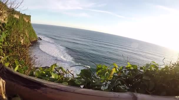 Pôr do sol em Pura Uluwatu. Ondas oceânicas e vista superior. Bali, Indonésia — Vídeo de Stock