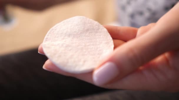 Pielęgnacja skóry - kobieta wylewa tonik oczyszczający na podkładkę bawełnianą, zbliżenie — Wideo stockowe