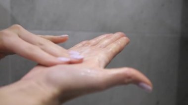 Doğal kozmetik ürünlerinin kullanımı. Yüz yıkama için köpük ovuşturan dişi avuçlar. Köpüren, nemlendirici cilt jölesi