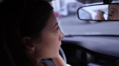 Güzellik ve çekicilik kavramı. Göz fırçası, arabadaki kadın. Kirpik kozmetik