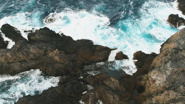Aerial view of the ocean waves and the beautiful rocky coast of the island of Tenerife. Dangerous waves crash against large rocks — Stock Photo, Image