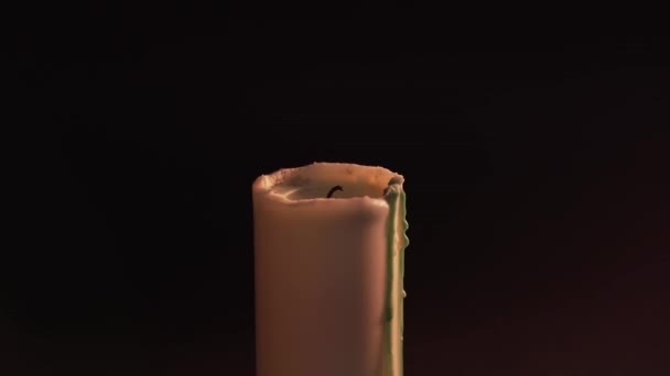 A mans hand sets fire to a candle on a black background with a match. Isolate, static shot. The concept of witchcraft, divination and magic — Stockvideo