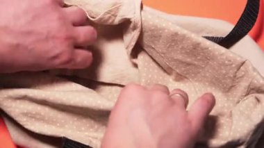 Life without plastic. Hands fold fresh vegetables into a cotton eco bag in the store. The concept of life without waste and concern for the environment