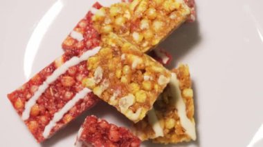 Timelapse footage eating granola bars from a white plate at a vegan party. Healthy snack close-up