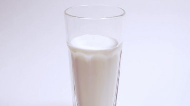 A hearty and healthy breakfast consisting of calcium and vitamins. Gradual filling of a glass with Greek yogurt on a white background, isolated