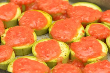 Pişirme önce domates sosu ile tepesinde kabak dilimlenmiş