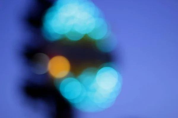Blue, red, yellow, blue, white blurred festive bokeh background with stars for Christmas