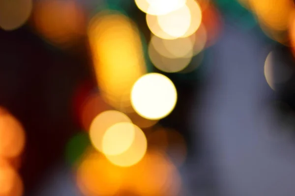 Blue, red, yellow, blue, white blurred festive bokeh background with stars for Christmas