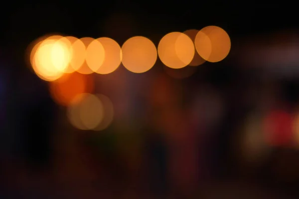 Blue, red, yellow, blue, white blurred festive bokeh background with stars for Christmas