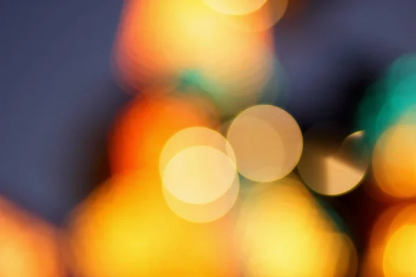 Blue, red, yellow, blue, white blurred festive bokeh background with stars for Christmas