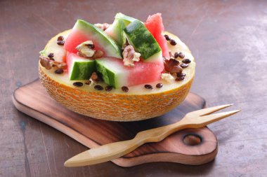 Bir ahşap tahta üzerinde ceviz serpilir karpuz, kavun dolması