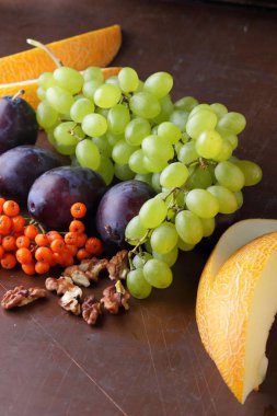 Erik, üzüm, üvez ve karanlık bir arka plan üzerinde ceviz