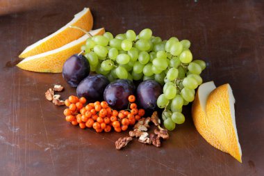 Erik, üzüm, üvez ve karanlık bir arka plan üzerinde ceviz