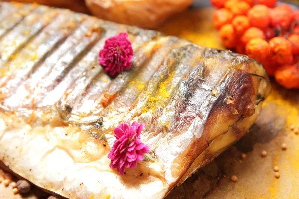 Grillowane ryby z ser, miód, jarzębiny, kalina, plasterki cytryny, pieczone ziemniaki, różowe kwiaty i przyprawy na pergaminie papieru — Zdjęcie stockowe