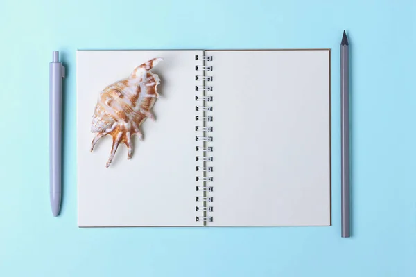 Stationery, pop art, surrealism, seashell on the office table, white blue fountain pen, gray fountain pen, pencil, open notebook, place for making contracts in the minimalist style, modern school education