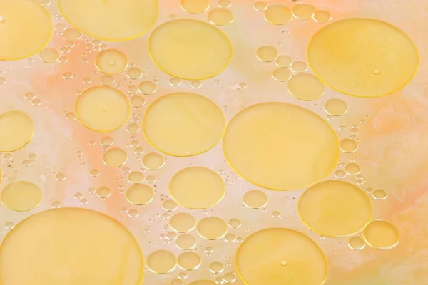 Drops of vegetable oil on liquid, abstract background, pop art texture, yellow circles on a light background, minimalism, pastel pattern