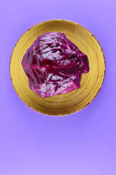 Purple cabbage on a yellow plate, cabbage on a purple background, minimalism, vegetables for vegan, sliced cabbage pop art, fresh vegetables on salad, packaging design, art