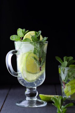 Mojito karanlık bir arka plan üzerinde yaz kokteyl ile limon, limon, taze nane Ice, vegan, kopya alanı, kokteyl, kutlama içmeye İçkiyle serinletici kokteyl minimalist