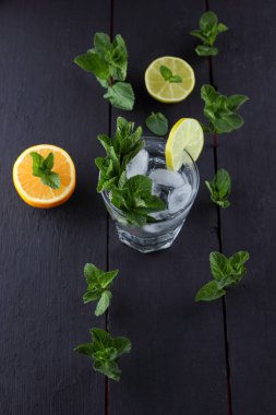 Mojito karanlık bir arka plan üzerinde yaz kokteyl limon ve nane, limon ile serinletici içecek, buz, sanat kopya alanı, minimalist kokteyl kokteyl, kutlama içmeye taze nane