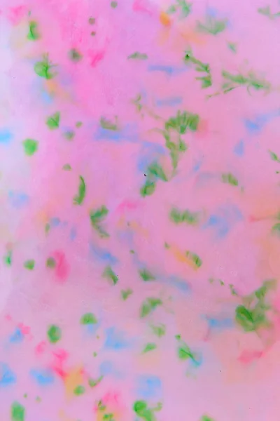 Multicolored pattern, colored spots on a pink background, abstract texture, minimalistic background, pop art blank for a designer, pattern for the design of fabric, multicolored stains on a liquid