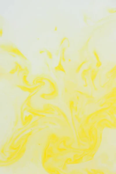 Abstract yellow background, pastel pattern, yellow paint in white liquid, stains on milk, art, minimalistic background, blank for designer, pop art, creative layout