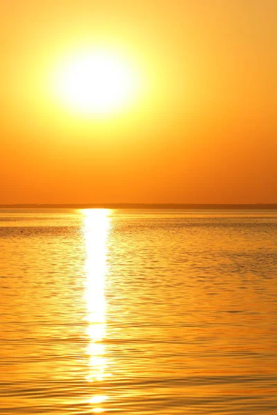 Orange sun over the sea horizon, beautiful sunset, copy space, landscape with a big sun, bloody horizon above the water surface, blank for the designer, orange pattern