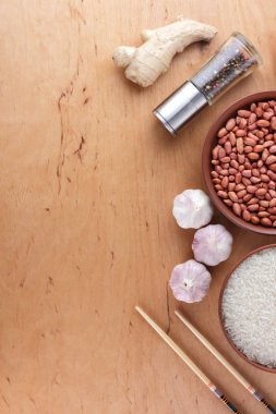 Çin Gıda katkı maddeleri, Kuruyemiş, sebze, zencefil kökü. Çin yemekleri tüm dünyada en popüler olanı. Çiğ pirinç ve baharat ahşap arka plan üzerinde. Sarımsak ve soğan yemek pişirmek için. Kopya alanı