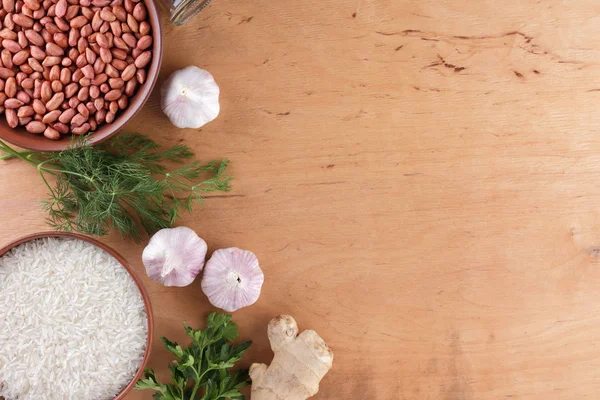 Çin ham maddeler, Kuruyemiş, sebze, zencefil kökü. Taze yeşillik, dereotu ve maydanoz. Pirinç ve baharat ahşap arka plan üzerinde. Sarımsak ve soğan yemek pişirmek için. Uzay kopyalayın. Sanat