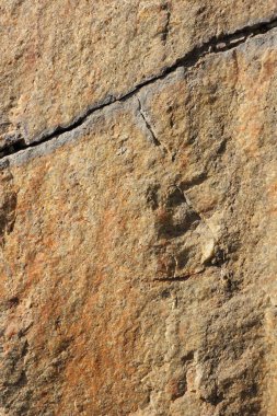 Doğal taş granit doku, granit desen. Taş benekli granit volkanik kaya Mutfak Tezgah vb için kullanılan arka plan. Kahverengi renk tonu ile mermer yüzey