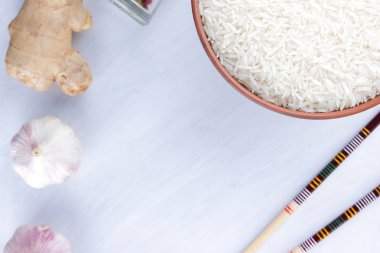 Çeşitli Asya vejetaryen yemek malzemeler. Kuruyemiş, sebze, zencefil kökü. Taze yeşillik, dereotu ve maydanoz. Pirinç, fıstık ve baharat beyaz zemin üzerinde. Uzay kopyalayın. Sanat