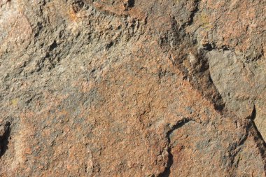 Doğal taş granit doku, granit desen. Taş benekli granit volkanik kaya Mutfak Tezgah vb için kullanılan arka plan. Kahverengi renk tonu ile mermer yüzey. Minimalizm