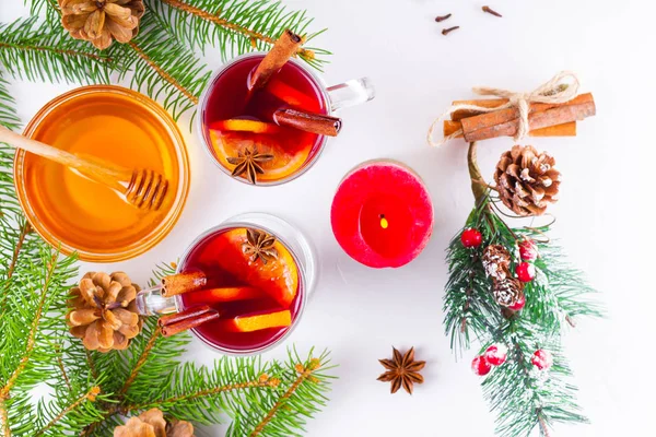 Mulled wine in glass mug with spices. Glasses of mulled wine with cinnamon, anise and fir tree branches. Winter Christmas drink. Top view. Flat lay