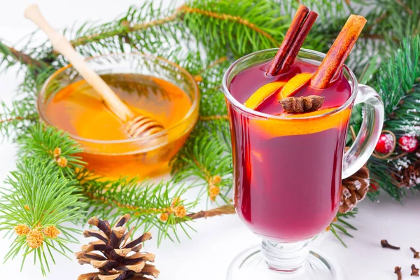 Mulled wine in glass mug with spices. Glasses of mulled wine with cinnamon, anise and fir tree branches. Winter Christmas drink. Top view. Flat lay