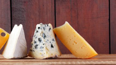 Tahta tahtalarda peynir. Camembert peyniri, sert sarı peynir, ahşap tahtalarda Dorblu. Geniş Ekran