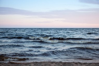 Kuzey deniz manzarası göl Onega Gölü üzerinde-batan güneşin ışınlarını yansıtan granit kıyıya dalgalar yendi.