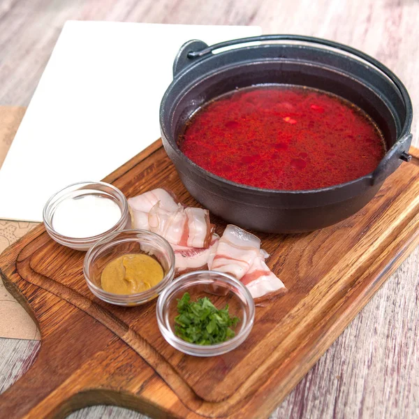 Borsch - traditional Ukrainian and Russian soup with red beets in ceramic bowl on wooden background — Stock Photo, Image