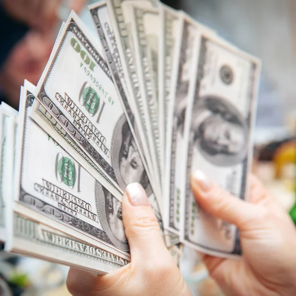 Hand holding dollar banknotes — Stock Photo, Image