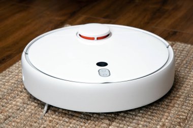 Robotik elektrik süpürgesi odayı toz ve enkazdan temizliyor, teknolojik ilerleme..