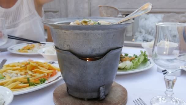 Diner in een Chinees restaurant. Een warme pot wordt verwarmd door een kaars. 4k — Stockvideo