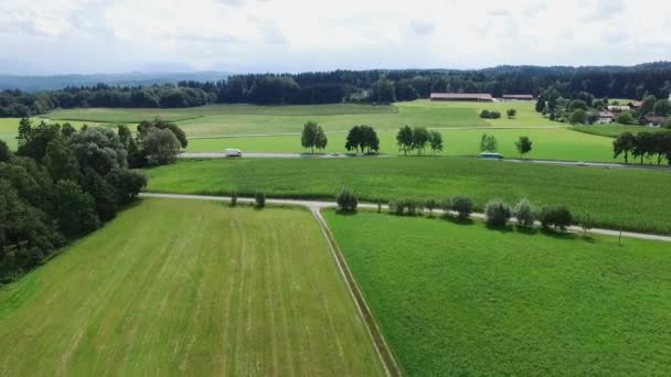 Imágenes aéreas de aviones no tripulados - volando sobre colinas y una pequeña carretera rural — Vídeos de Stock