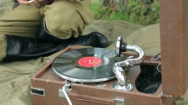 The army of the USSR. Soviet army soldiers are resting. Soldiers listen to a gramophone. Soviet Union soldiers in camp. Reconstruction of the Soviet army. Video Clip