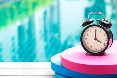 swimming times, retro black bell clock time at 4 o'clock at swimming pool blur background. clipart